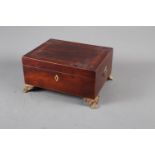 A mahogany and banded jewellery box with brass handles, on paw supports, 11" wide