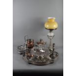 A silver plated oval two-handled tea tray, 21" wide, a pair of plated candlesticks, an oil lamp,