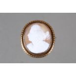 A carved shell cameo brooch, in yellow metal frame