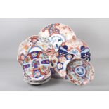 Three Imari shaped dishes, 12", 13" and 14" dia, and seven Imari decorated plates, 8" dia (damages)