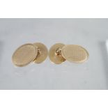 A pair of engine turned 9ct gold cufflinks, 6g