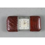 A brown leather clad Movado purse watch with silvered dial and baton and Arabic numerals