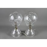 A pair of cut glass globe table lamps, on circular bases, 14" high