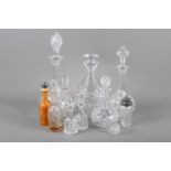 Four assorted cut glass decanters and assorted glass condiment bottles