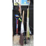 A besom broom, a mattock and other garden tools