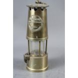 A miner's brass lamp, "The Protector", by Eccles of Manchester, 10 1/4" overall