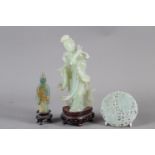 A Chinese jade carving of Kuan-Yin, on wooden base, 8 1/2" high, a smaller jade carving of an