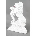 A white painted iron door stop, cast as a rampant lion, 15" high, and a modern wall hung barometer