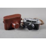 A Fed 4 rangefinder camera, number 6676147, in leather case