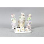 Three Continental figures and a crested china miniature part teaset (damages)