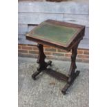 A 19th century carved oak and blind fretwork desk, fitted tooled lined top, on panel end supports,