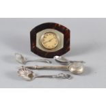 A tortoise shell and silver plated eight-day strut clock, a silver plated tea infuser and three