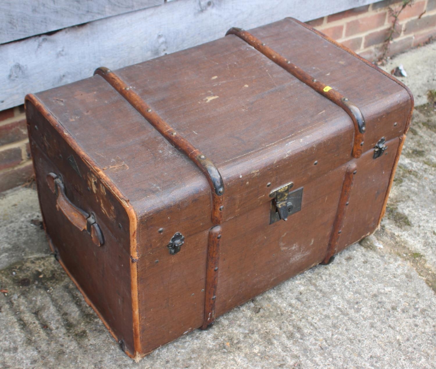 A late 19th century canvas and maple bound travel trunk with fitted interior and lift-out tray
