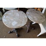 A pair of circular marble topped bistro tables, on cast iron support, 19" dia