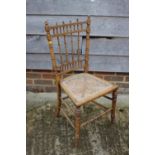 A late 19th century birch spindle back bedroom chair with cane seat and two other bedroom chairs