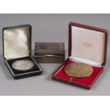 A silver cigarette box with engraved initials, a "The Champagne Academy Old Boys Association" medal,
