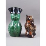 A slipware owl jug, 6 1/4" high ("ear" missing) and a "guardsman" jug, 8" high