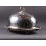 A silver plated two-handled tree and well meat dish and associated dome, on scroll feet, dish 24"