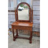 A Biedermeier figured mahogany dressing table with arch top mirror, over single drawer, on turned