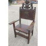 A Renaissance Revival carved walnut armchair with lion and coat of arms top rail, and leather seat