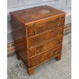 A bachelor's figured walnut and banded chest of four drawers, on bracket feet, 24" wide x 17 1/2"