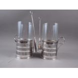 A pair of glass and silver plate mounted storm lamps with pierced decoration and snuffers