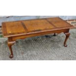 A walnut and banded coffee table, on cabriole supports, 48" wide x 22" deep x 17 1/2" high