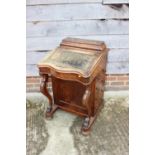 A Victorian figured walnut Davenport with stationery compartment over lift-up writing slope and four