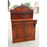 A late 19th century mahogany ledge back chiffonier with frieze drawer over cupboards, on block base,