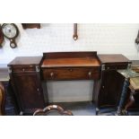 A Regency mahogany and brass mounted drop centre double pedestal sideboard, fitted three drawers and