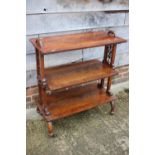 A late Victorian figured mahogany and banded three-tier etagere, on splay castored supports, 30"