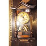 A mahogany cased wall clock, flanked by carved panels with gilt dial and Roman numerals, 16" high