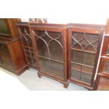 An Edwardian mahogany and line inlaid breakfront bookcase enclosed Gothic lattice glazed doors, on