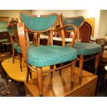 A set of four plywood and bentwood armchairs, upholstered in a green mottled vinyl, on tapered and
