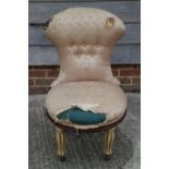 A spoon back revolving occasional chair, upholstered in a cream floral fabric, on fluted supports