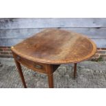 An 18th century mahogany and satinwood banded oval Pembroke table, on square taper castored