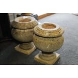 A pair of marble urns, on square bases, 12" high