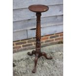 A 19th century mahogany spiral turned torchere, on tripod splay supports, 9 1/2" dia x 36 1/2" high