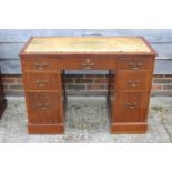 A sapele mahogany double pedestal desk with cream leather lined top, fitted seven drawers, 41 1/2"