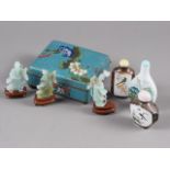 A cloisonne cigarette box, 4" wide, three snuff bottles and three jade figures, 2" high, on stands