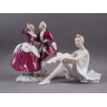 A Royal Dux Bohemia figure of a seated ballerina, 6 3/4" high, a Royal Dux Bohemia figure group of a