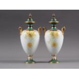 A pair of Royal Crown Derby baluster pedestal two-handled vases and covers with floral decoration