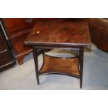 An Edwardian carved mahogany fold-over patience table, on splay supports, united by a galleried