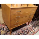 A 1970s teak chest of four long drawers, on splayed supports, 35 1/2" wide x 19" deep x 32" high