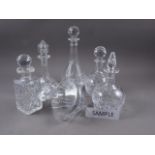 Approximately twenty-five clear, cut and moulded glass decanters of various sizes