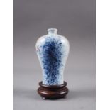 A Chinese meiping vase, decorated blue and iron oxide sprays, 3 1/4" high, on associated hardwood