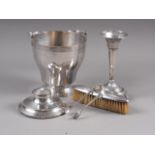 A silver plated ice bucket, a pair of silver sugar tongs, a silver flared rim vase, an inkwell and a