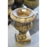 A marble campana urn, on square base