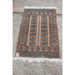 A Bokhara rug of traditional design in shades of rust, red, blue and natural, 47" x 33" approx,