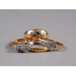 A 22ct gold wedding band, size N, 3.9g, an 18ct gold three-stone gypsy ring, a yellow and white